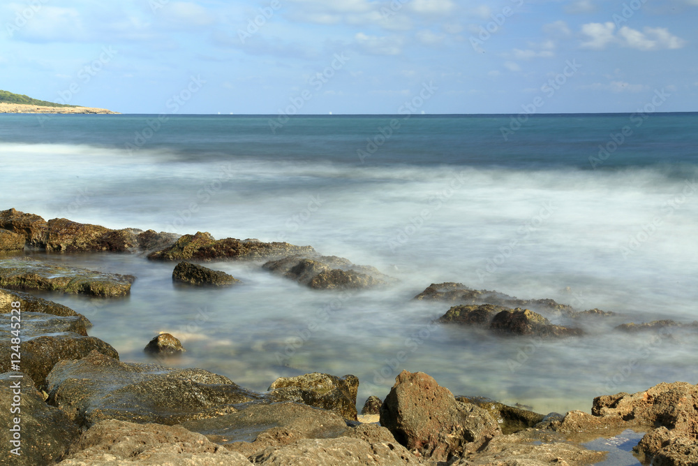 waves crashing on stones, long exposure