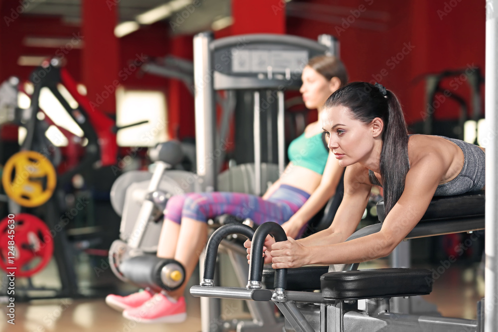 Fototapeta premium Young women training in modern gym