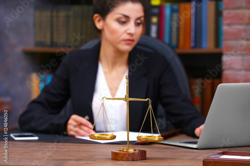 Scales of justice on wooden...