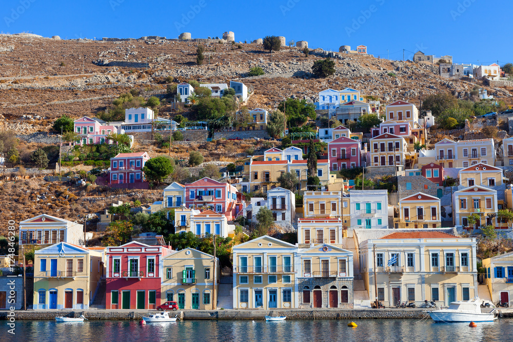 Symi island - Colorful houses and small boats at the heart of the village