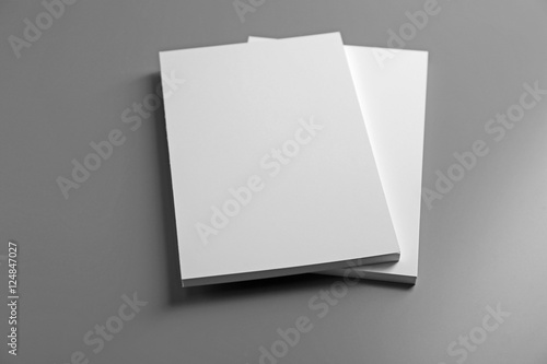 Blank notebooks on grey background photo