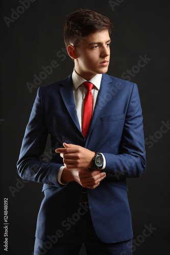 Young man posing in classic blue suit.