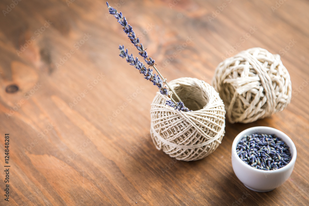 lavender flowers with spool of thread on a wooden background lavender flowers with spool of thread on a wooden background