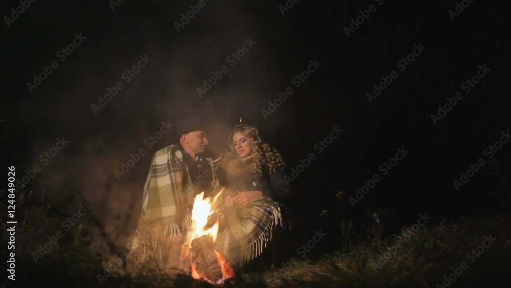 Camp Fire and Happy Couple. Nightscape with campfire and happy couple. Camp Fire and Happy Couple. Nightscape with campfire and happy couple.