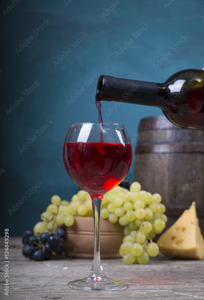 pouring red wine on background