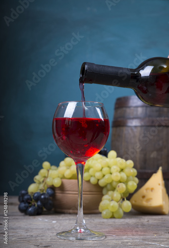 Fototapeta Naklejka Na Ścianę i Meble -  pouring red wine on background