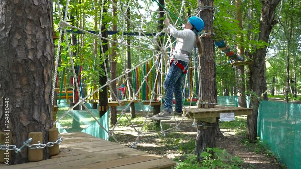 girl passes a rope obstacle course girl passes a rope obstacle course