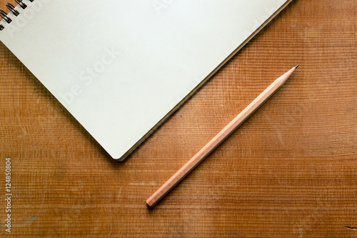 Top view of notebook on wood background