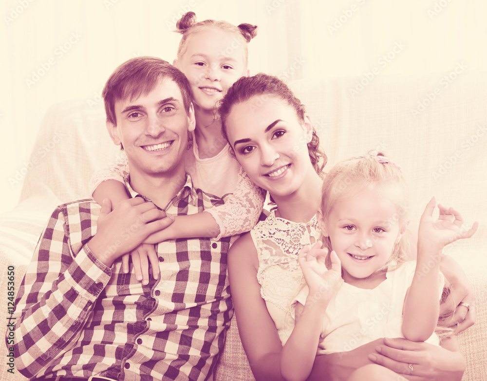 Relaxed family of four posing