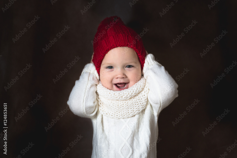 naughty baby girl in bright cap brown background, Christmas and naughty baby girl in bright cap brown background, Christmas and