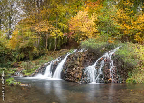 Waterfall in the forest in autumn © niki spasov