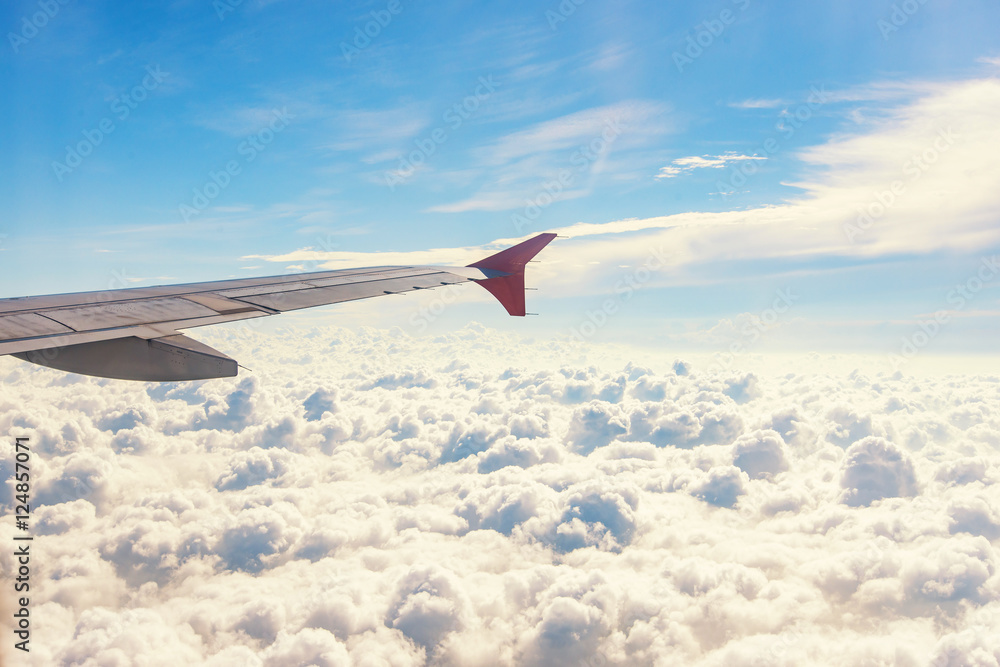 Fototapeta premium View from airplane window. Wing of an airplane flying above the
