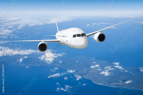 Obraz Podróż samolotem, samolot latający w błękitne niebo nad chmurami
