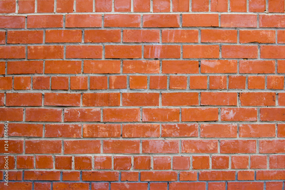 Fototapeta premium Wall of red bricks. Textured background closeup.