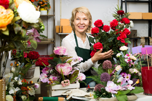 Florist with a bouquet of red roses