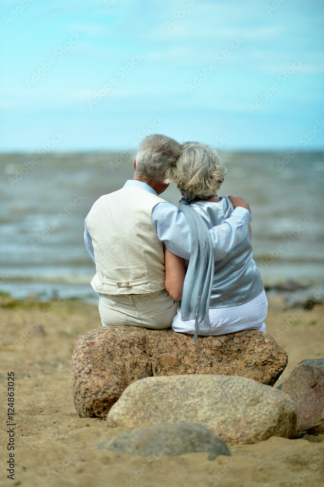 Fototapeta premium Senior couple at sea at sunset