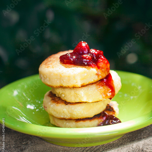 Sweet ricotta pancakes with jam, closeup, selective focus photo