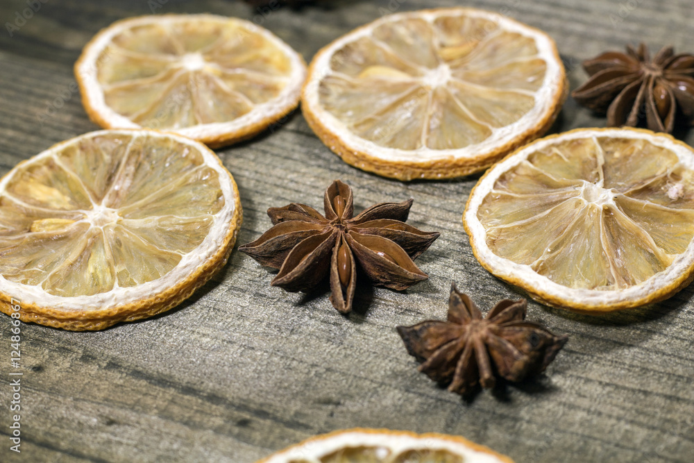 Dried lemon slices with star anise on wooden table. Dried lemon slices with star anise on wooden table.