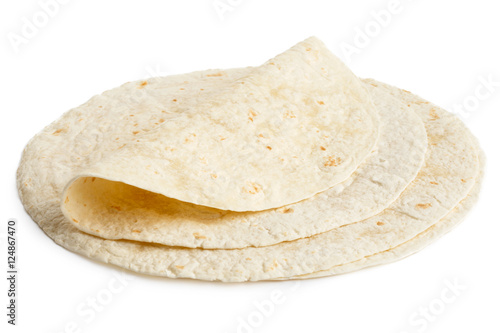 Stack of tortilla wraps and one folded wrap isolated on white. photo