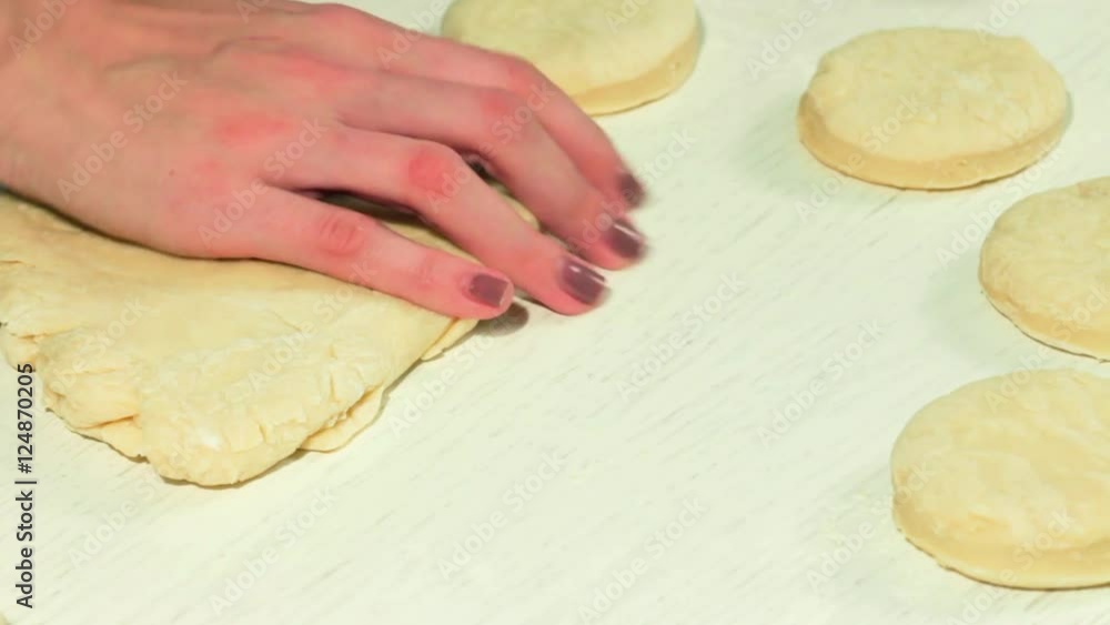 female hands taking rolling pin for making dough on board female hands taking rolling pin for making dough on board