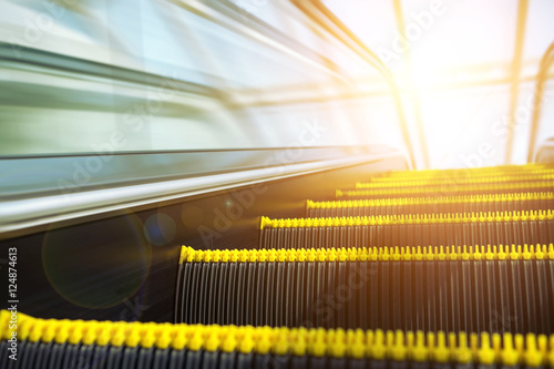 Blurry modern escalator at sunny day. photo