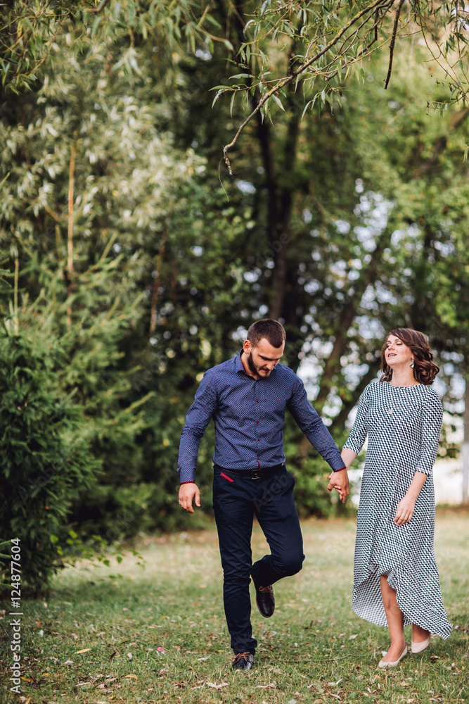 Happy pregnant woman and her husband in the park Happy pregnant woman and her husband in the park