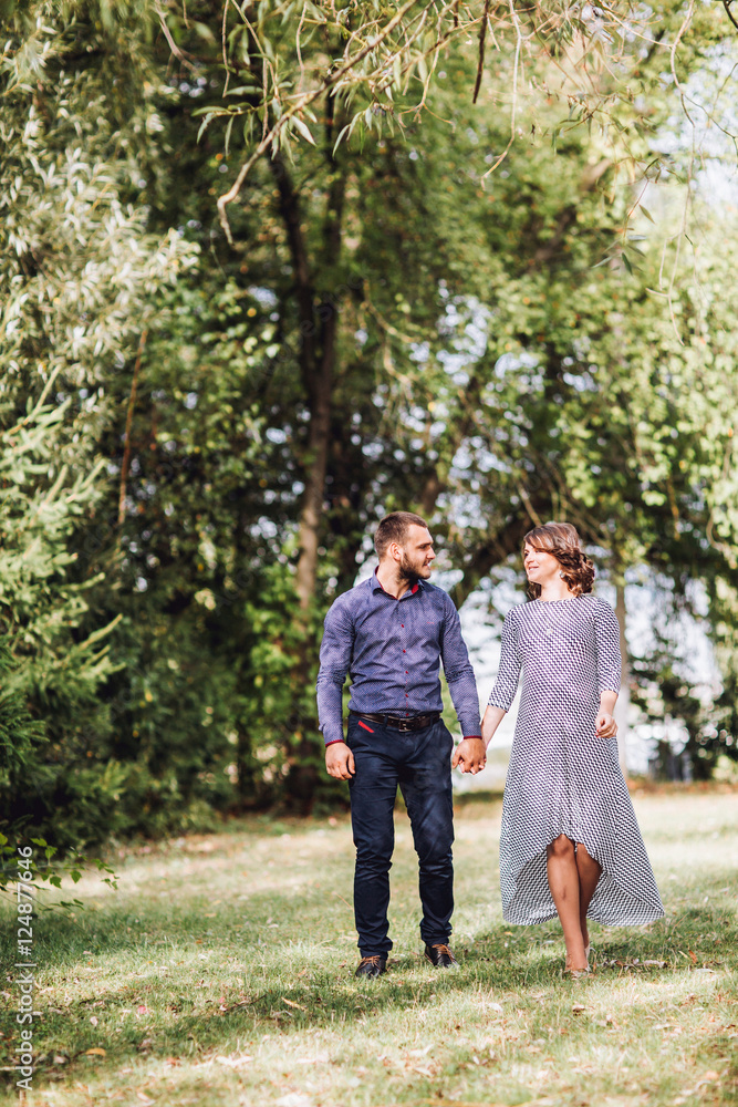 Happy pregnant woman and her husband in the park Happy pregnant woman and her husband in the park