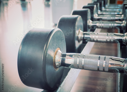 Dumbbell in at the gym room /Color filter and selective focus