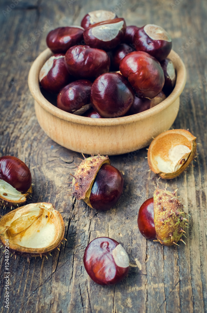 Fresh chestnuts on the old wooden table Fresh chestnuts on the old wooden table