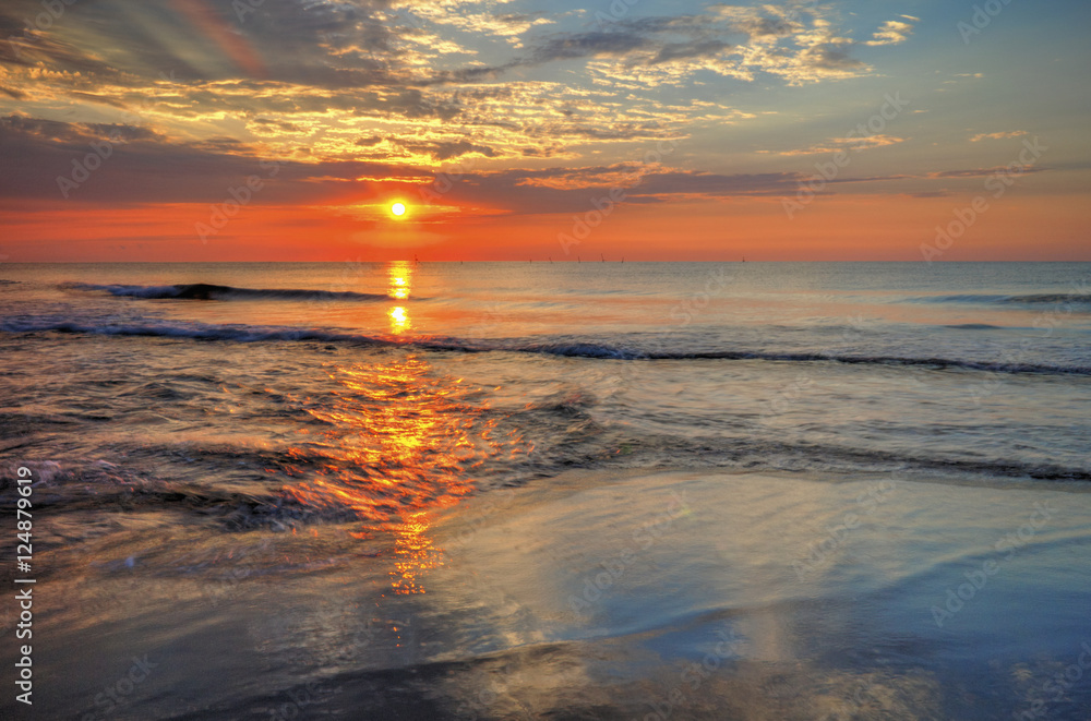 Beautiful sunrise over the sea with dramatic clouds on the sky Beautiful sunrise over the sea with dramatic clouds on the sky