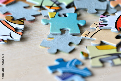 Children's puzzles on a wooden background close up © Talulla