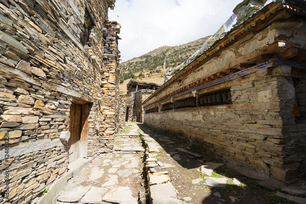 Traditional stone build village of Nepal. Mountains in the background. Selective focus. Traditional stone build village of Nepal. Mountains in the background. Selective focus.