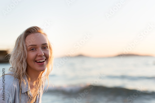 Happy carefree woman dancing at sunset on the beach. Happy free