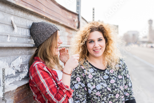 Two young curly and straight blonde hair woman photo