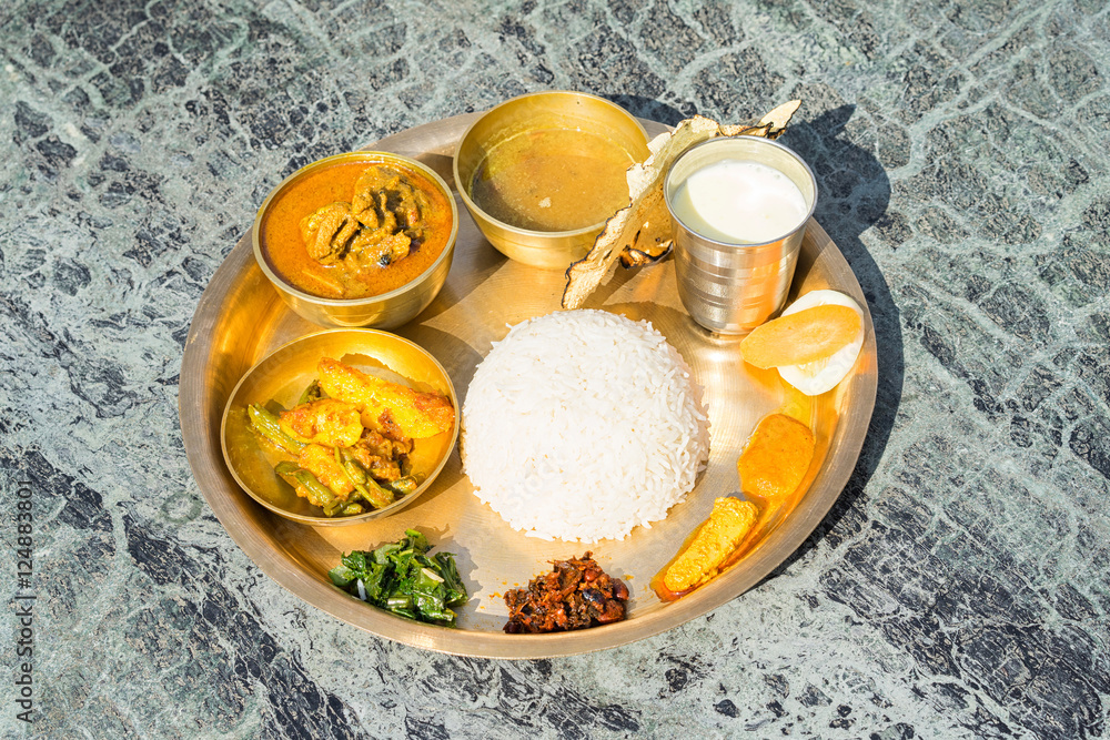 Traditional Nepalese food - thali (dal bhat) in a restaurant. foto de Stock  | Adobe Stock