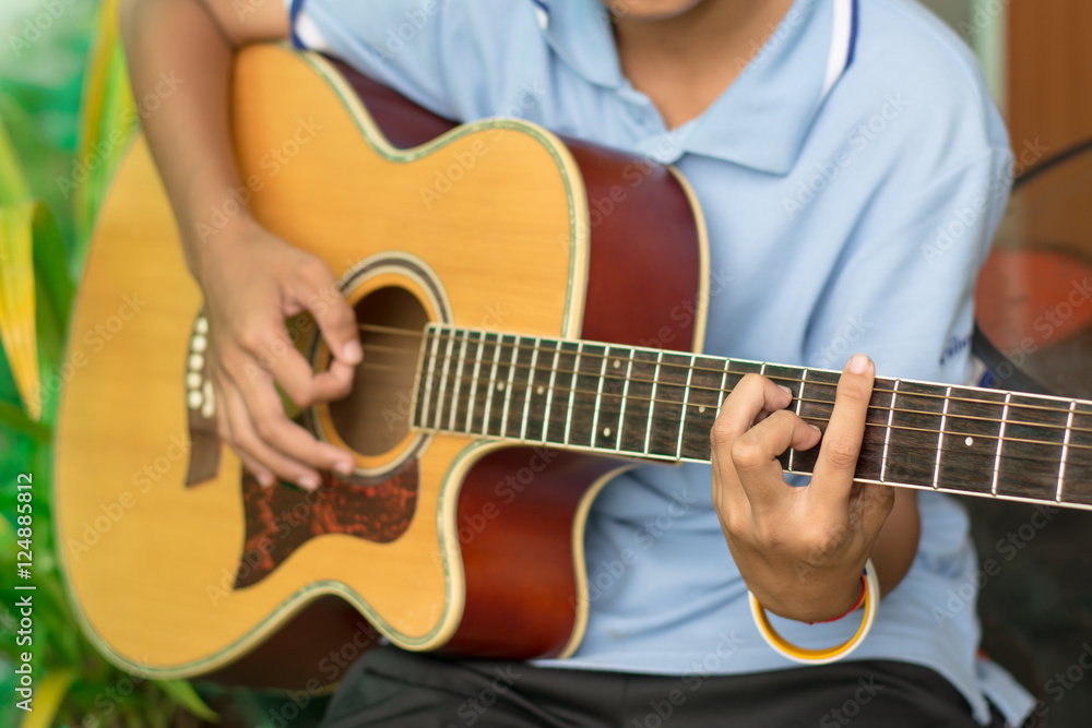 A boy playing guitar