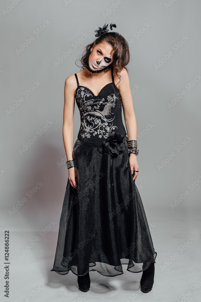 Portrait of young woman with skull make-up. Portrait of young woman with skull make-up.