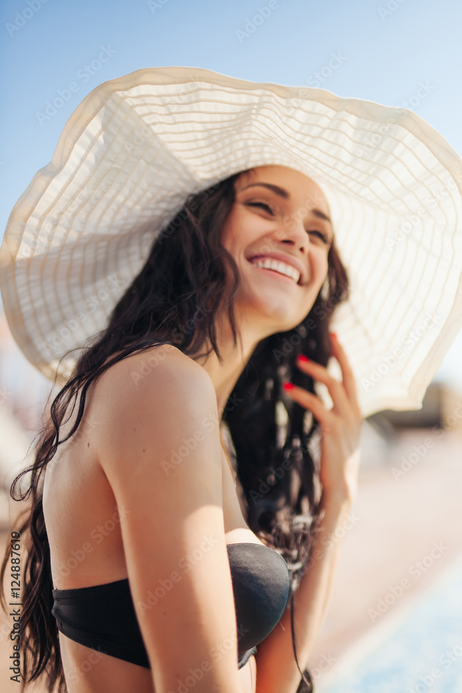 Portrait of young woman in hat on a sunny day
