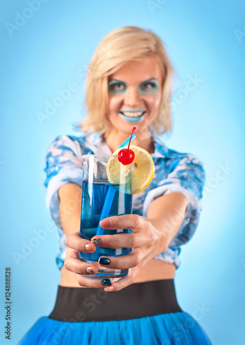 Young beautiful woman with cocktail "Blue lagoon"
