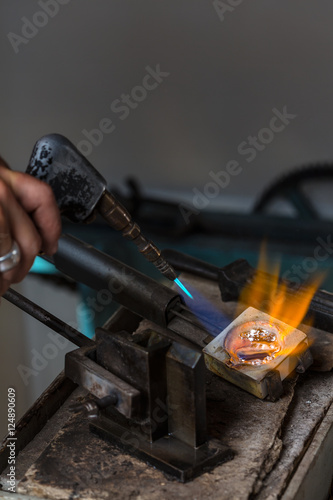 Melting Silver Grains to liquid state in crucible with blowtorch; Goldsmith Workshop; Close-up