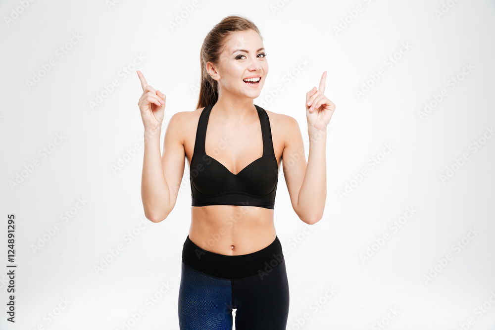 Portrait of a happy fitness woman pointing two fingers up Portrait of a happy fitness woman pointing two fingers up