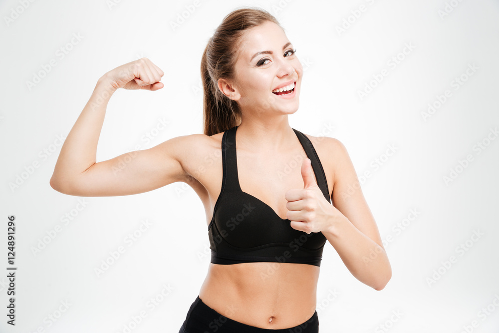 Happy sporty woman showing ok sign with fingers Happy sporty woman showing ok sign with fingers