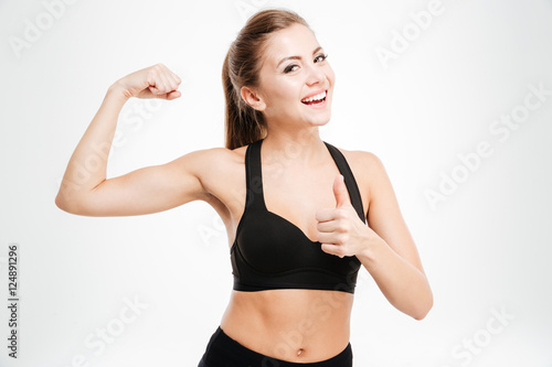 Happy sporty woman showing ok sign with fingers