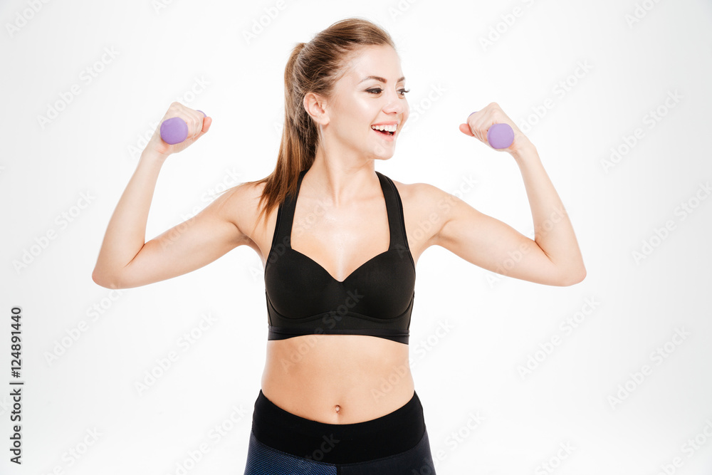 Smiling fitness woman workout with small dumbbells Smiling fitness woman workout with small dumbbells