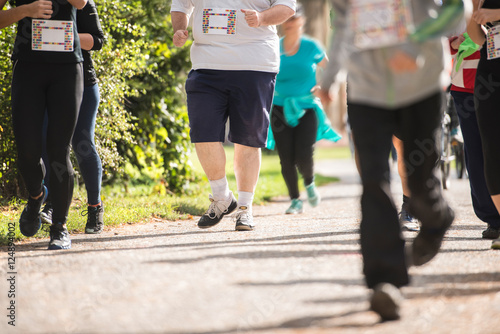 Group of unrecognizable runners outdoors. Long distance running.