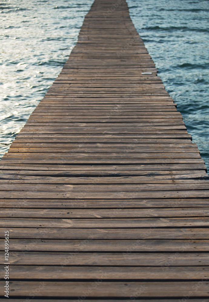 Fototapeta premium Old wooden pier leading to the sea.