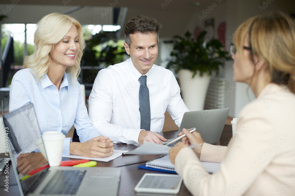 Shot of an investment advisor businesswoman consulting with middle aged couple in their home. Shot of an investment advisor businesswoman consulting with middle aged couple in their home.