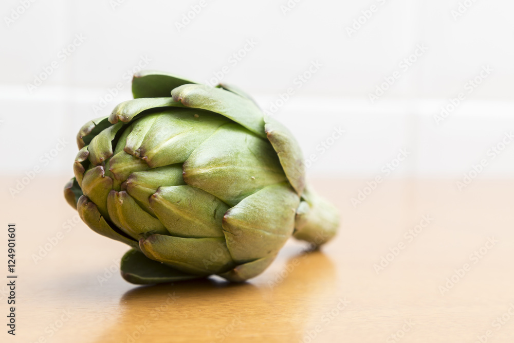 Fototapeta premium Green artichoke on the table