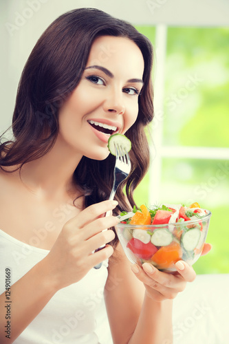 beautiful woman eating salad, indoor