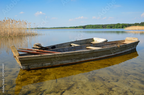 Transparent lake with small wooden boats